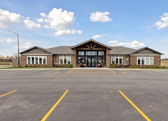 A building with a parking lot in front of it.