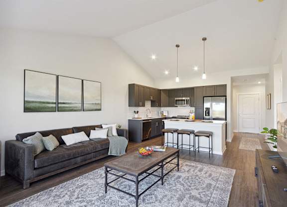 A modern living room with a grey couch and a coffee table.