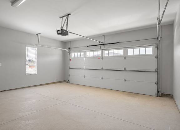 A spacious garage with a lift system installed.