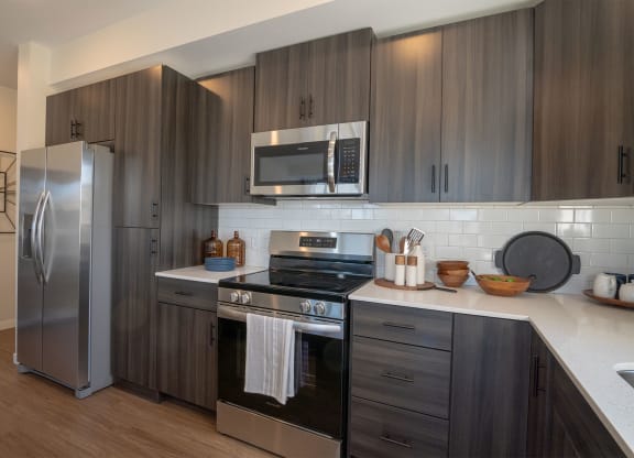 a kitchen with stainless steel appliances and wooden cabinets