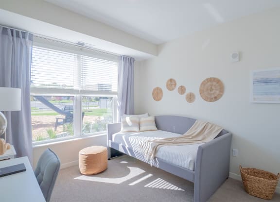 a bedroom with a bed and a large window