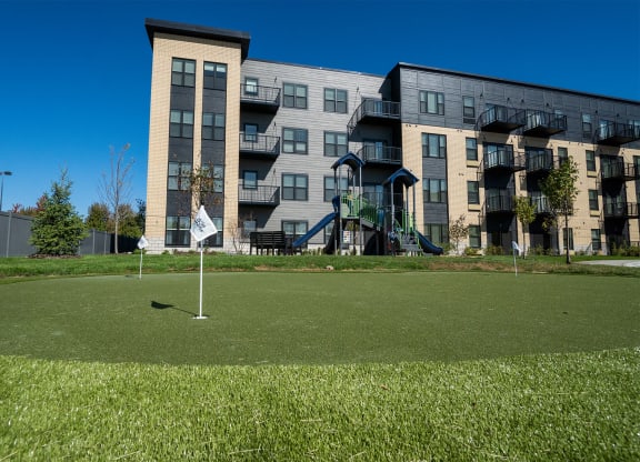 a golf course in front of an apartment building