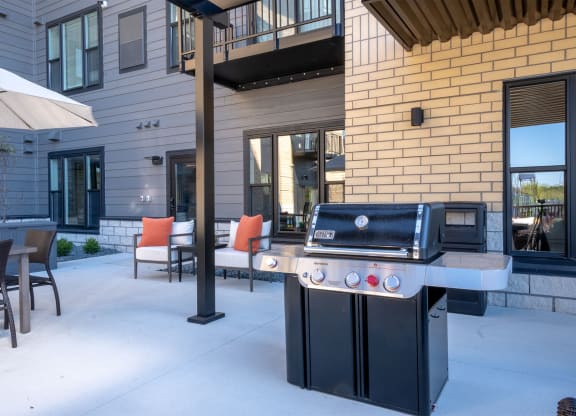 a barbecue grill on the patio of a house