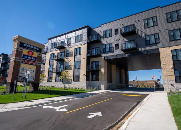 an apartment building with an overpass and a street