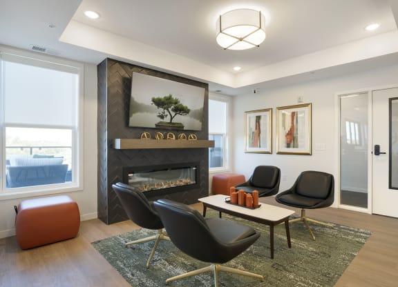 a living room with a fireplace and chairs