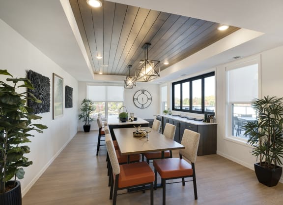 a dining room with a wooden ceiling and a table and chairs