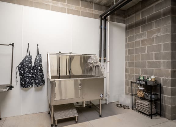 a stainless steel cabinet in a room with a brick wall