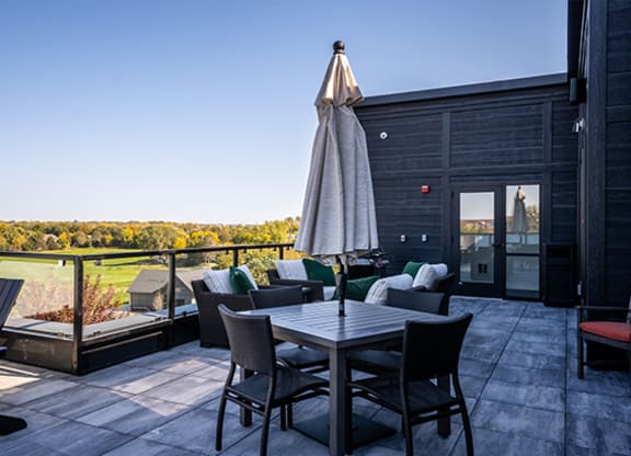 a patio with a table and chairs and an umbrella