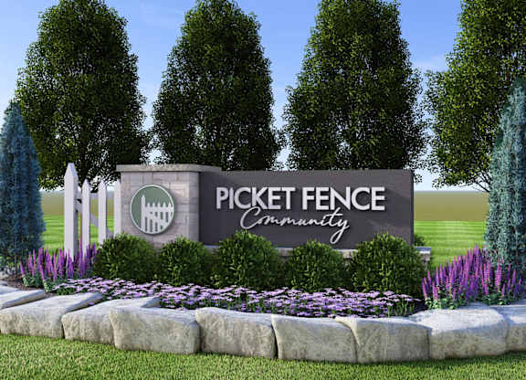 A sign that says Pickett Fence Community in front of trees.