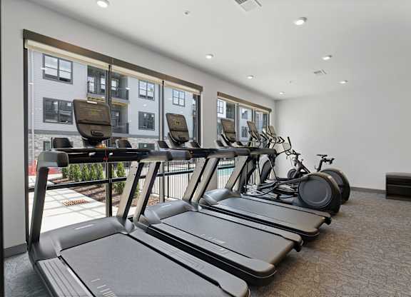 A gym with treadmills and exercise bikes.