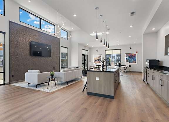 A modern living room with a flat screen TV mounted on the wall.