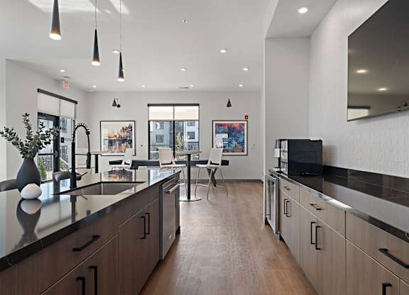A modern kitchen with dark wood cabinets and a black countertop.