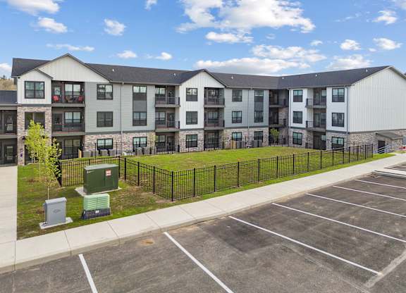 A large building with a parking lot in front of it.