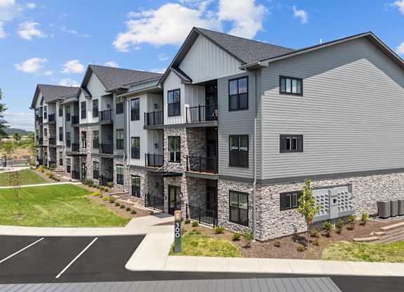 A row of modern townhouses with a clear blue sky above.
