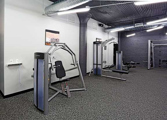A gym with a variety of equipment including a leg press machine.