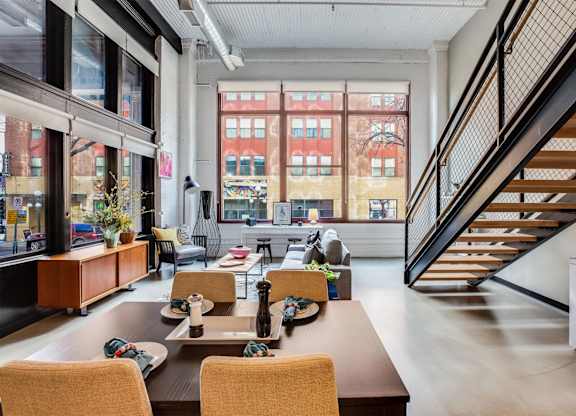 A modern dining room with a long table and chairs.