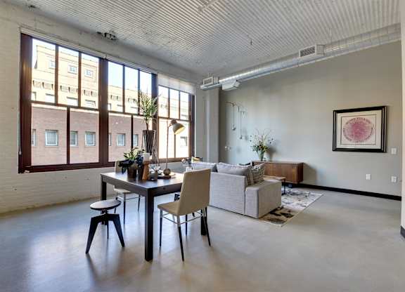 A dining room with a table and chairs.