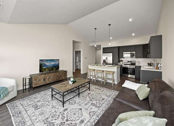 A modern living room with a brown couch and a coffee table.