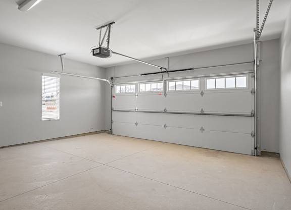 A spacious garage with a lift system installed.