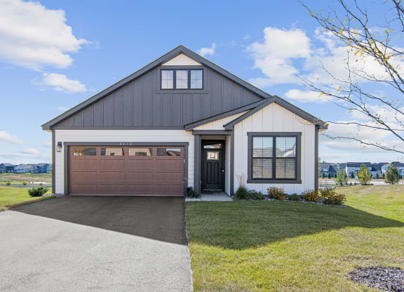the front of a house with a garage door