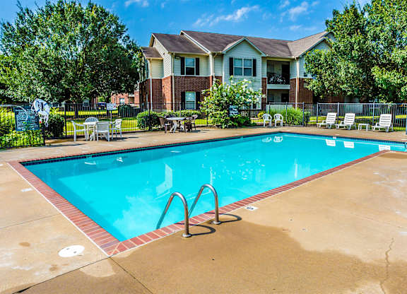 A swimming pool in front of a house.