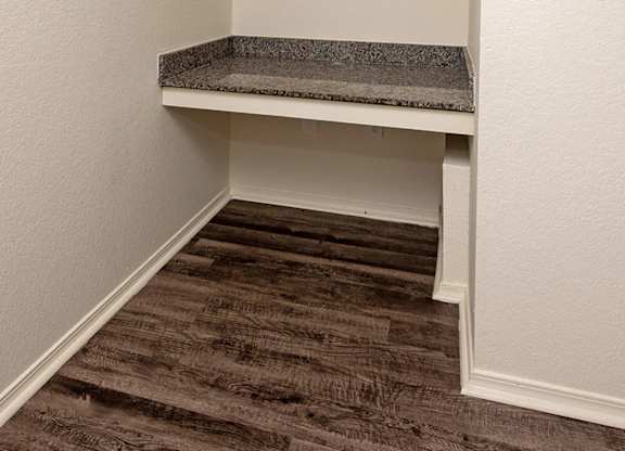 A small room with a bed and a carpeted floor.