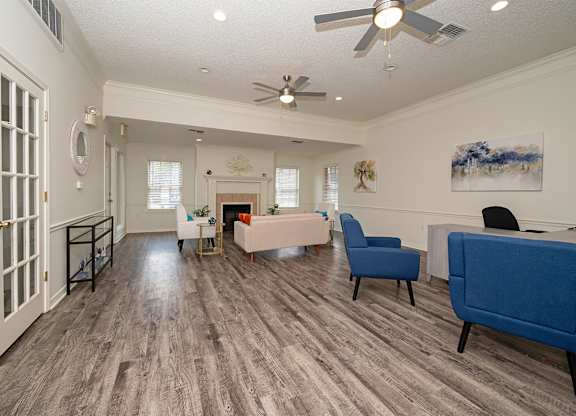 A living room with a blue couch and a fireplace.
