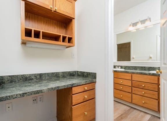 a kitchen with granite counter tops and wooden cabinets