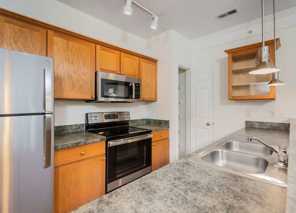 a kitchen with stainless steel appliances and granite counter tops