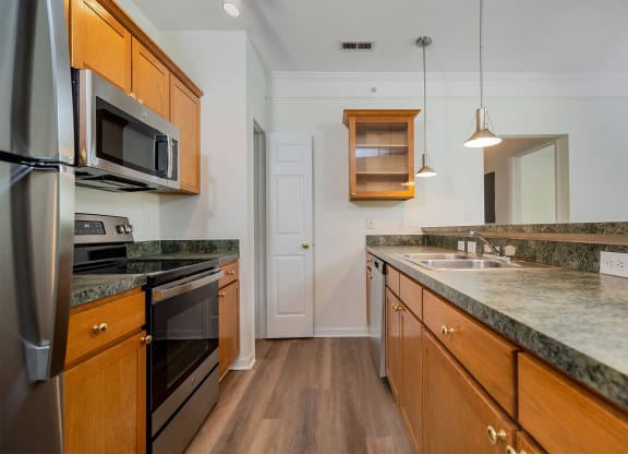 a kitchen with granite counter tops and stainless steel appliances
