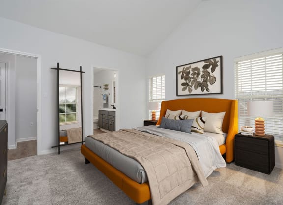 a bedroom with a bed and a mirror and a bathroom