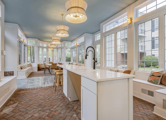 a kitchen with large windows and a counter top