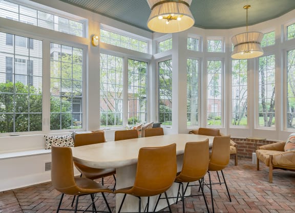 a large conference room with large windows and a table and chairs