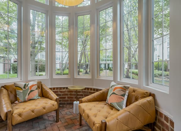 a living room with two couches and a row of windows