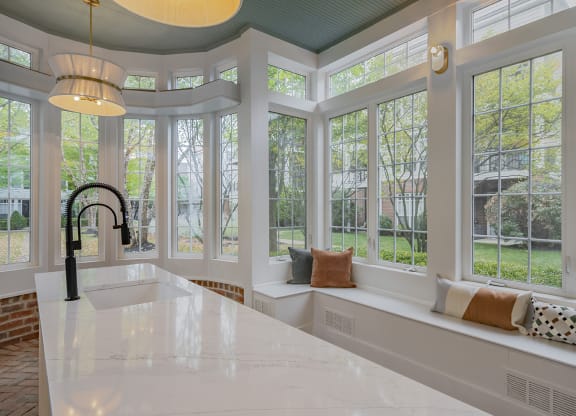 a kitchen with a sink and a row of windows