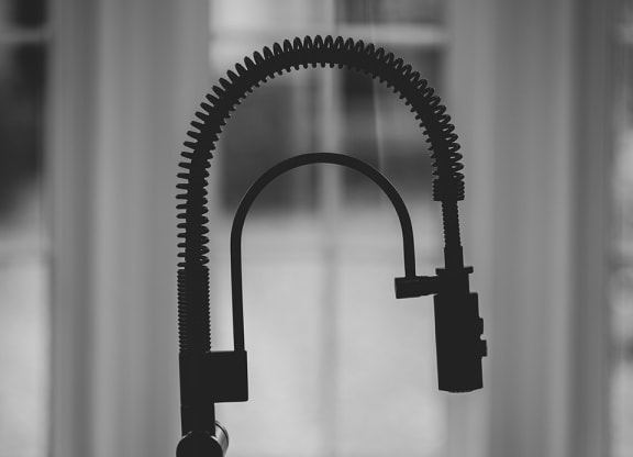a black and white photo of a microphone on a table