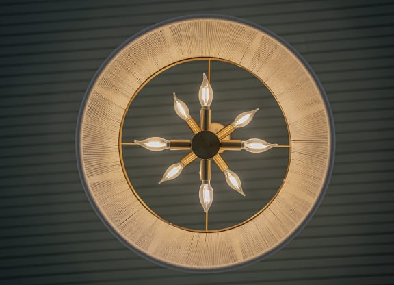a circular wall clock with four spoons on it