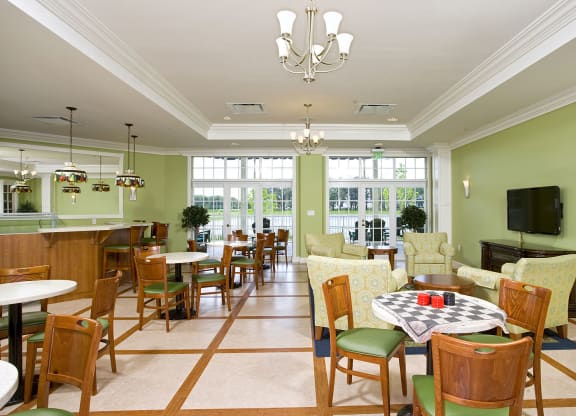 a large room with green walls and a large windowat Arbor Oaks at Lakeland Hills, Lakeland Florida