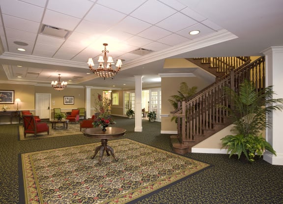 a large lobby with a staircase and chandelier at Arbor Oaks at Lakeland Hills, Florida