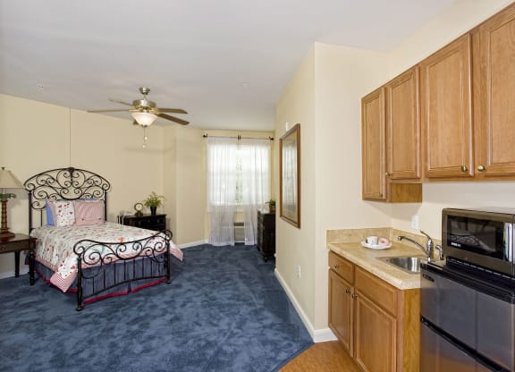 a bedroom with a bed and a ceiling fanat Arbor Oaks at Lakeland Hills, Lakeland, FL