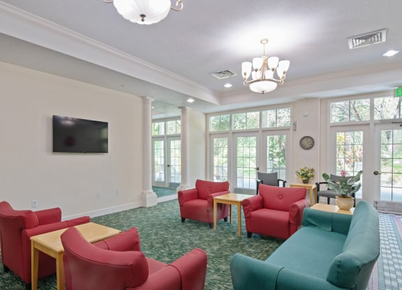 a room with couches chairs and a television at Arbor Oaks at Greenacres, Greenacres, FL