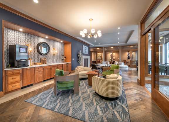 a lobby with couches and chairs and a bathroom with a sink