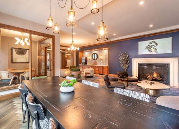 a living room with a large table and a fireplace