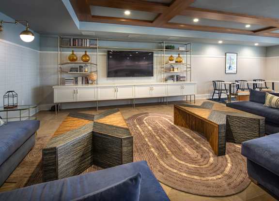 a living room with couches and tables and a television