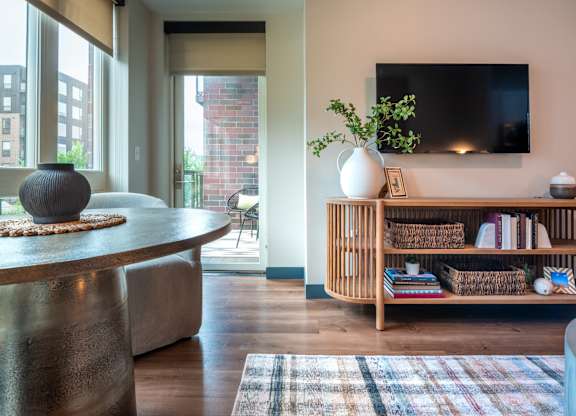a living room with a table and a television