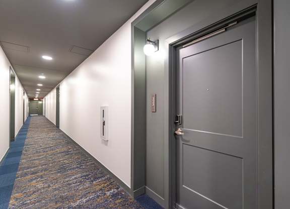 a view of a hallway with a large glass door with numbers on it