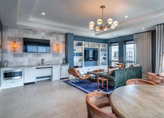 a living room and kitchen with a table and chairs