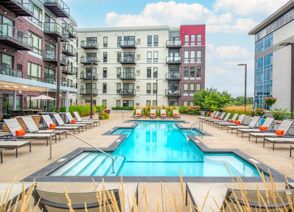 a swimming pool in front of an apartment building