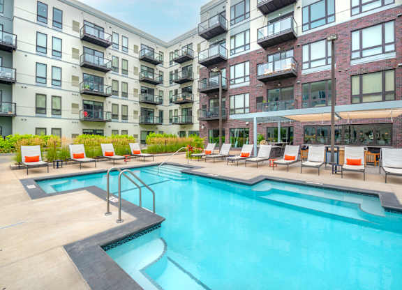 a swimming pool in front of an apartment building
