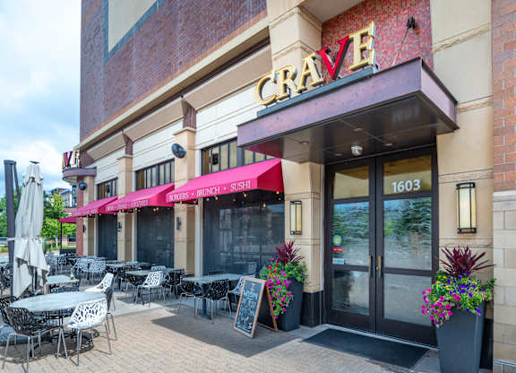 a restaurant with tables and chairs outside of the craigslist building
